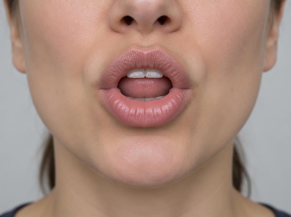 Real mouth position for sh, with the tongue blade raised behind the teeth